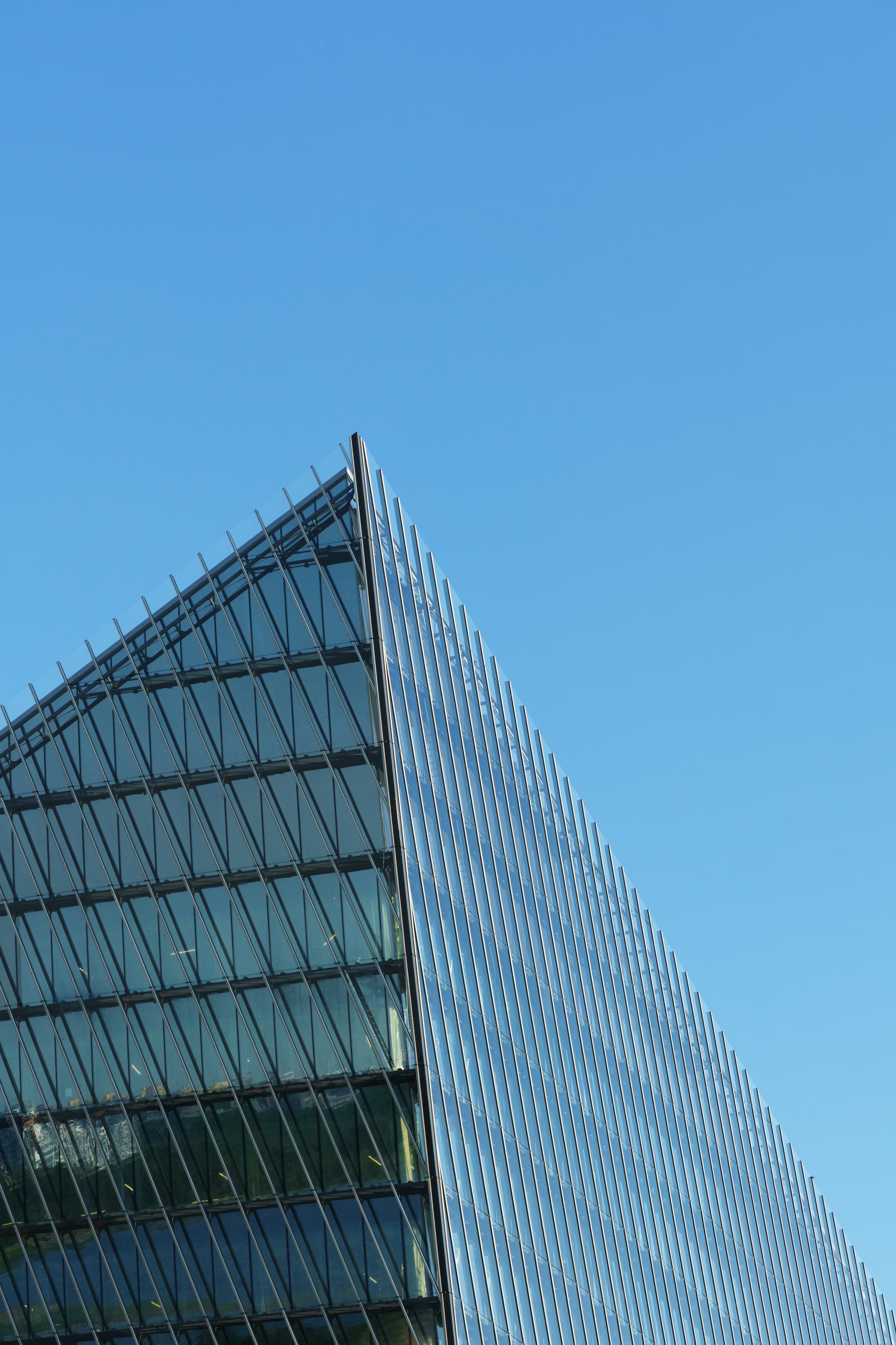 Glass banking district tower against a blue sky